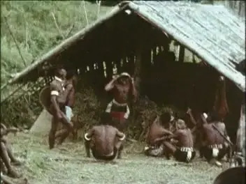 Men carrying rice and flinging straw out of winnowing hut